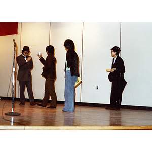 Four people performing a theatrical sketch