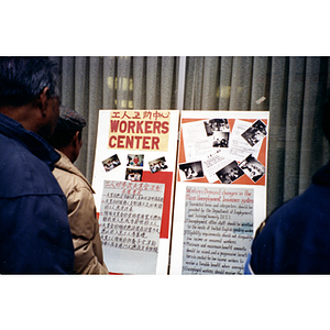 Residents view posters on unemployment insurance reform petition