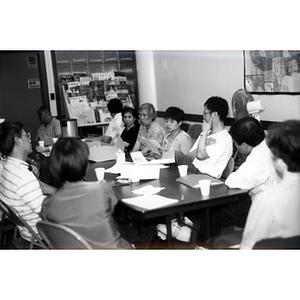 Lydia Lowe reading aloud at a Workers' Center meeting