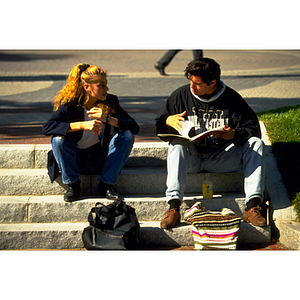 Students sitting in the Snell Library courtyard