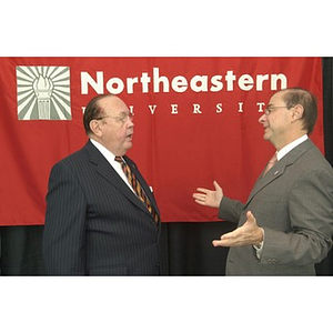 President Aoun gestures in conversation with Richard Egan at the Veterans Memorial dedication ceremony