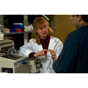 A female faculty member, left, instructs a student in the chemistry laboratory