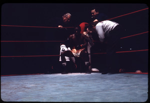 Boxer and trainers in the corner of the ring