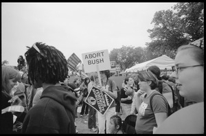 Marchers on the National Mall for the 2004 March for Women's Lives, one with a sign reading 'Abort Bush'