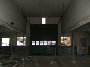 Interior view: looking toward garage door at end of building