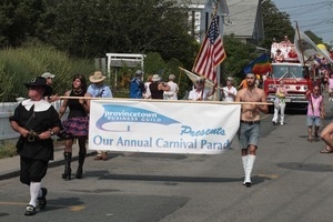 Man dressed in a Puritan costume leading the parade : Provincetown Carnival parade