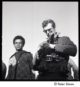 Photographer, decked out with cameras, at the Be-In, Central Park, New York City