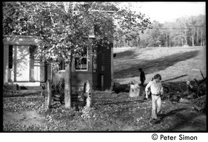 James (Lazarus) Tapley walking in front of the house, Montague Farm commune
