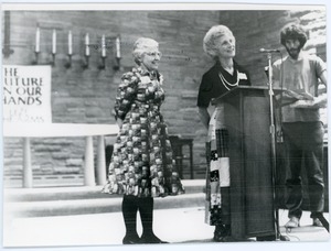 Frances Crowe (left) and unidentified woman: full length portrait at the podium at the Edwards Church during a Nuclear Freeze rally