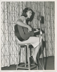 Young girl playing guitar at Christmas party