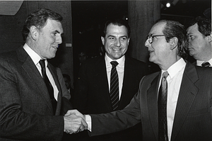 Mayor Raymond L. Flynn shaking hands with painter Francisco Rodón while City Councilor Robert Travaglini looks on
