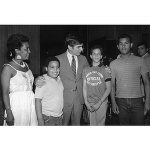 Governor Michael Dukakis stands with Carmen Pola and two youths at the Celtics Victory Party on 6 June 1984