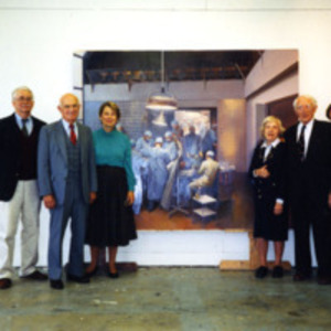 Joseph Murray standing beside the painting "The First Successful Kidney Transplantation"