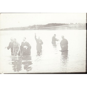 Reverend Dr. Wm. Frederick Fisher completes a baptism in a river