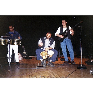 Alex Alvear (right) and other Areyto musicians performing at the Tobin School.
