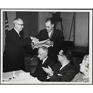 William H. Montgomery, at far left, presents an award to Dwight P. Robinson, Jr. at the Boys' Club Annual Recognition Dinner at the Boston Museum of Science