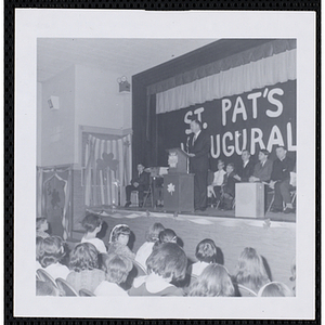 Donald M. DeHart address an audience of children at a Boys' Club of Boston St. Patrick's Day inaugural ball and exercises event