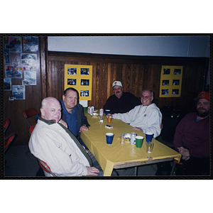 Five men sit at a table during a Bunker Hillbilly alumni reunion event