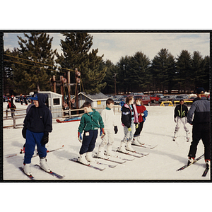 A group of children take ski intruction at a resort