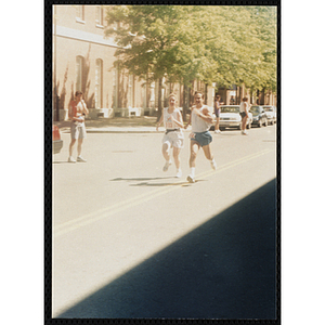 A woman and a man run the Battle of Bunker Hill Road Race