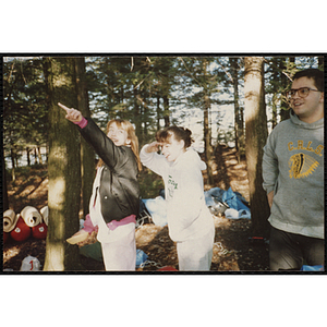 Two girls pose for a candid shot outdoors on a camping trip