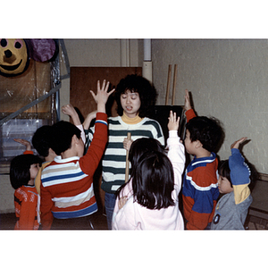 Guests ask to swing at a piñata during the Chinese Progressive Association's children's party