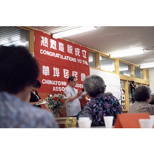 Man addresses a crowd gathered for a celebration of the Chinese Resident Association