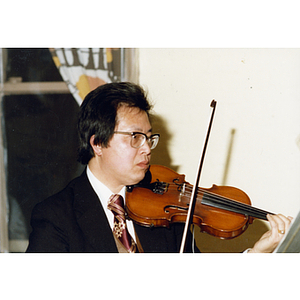 Musician performing at a Chinese Progressive Association party