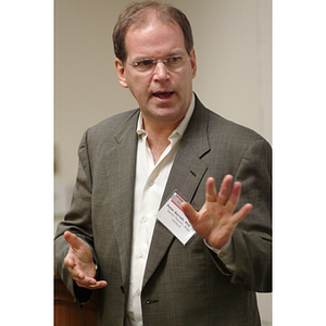 Peter Barrett, PhD '79, gestures while speaking at the NU Today Cancer Research Panel