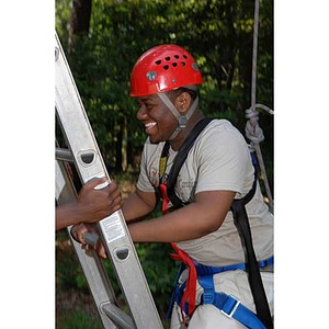 Ulysses Ifill climbs a ladder at the Torch Scholars Project Adventure Ropes Course