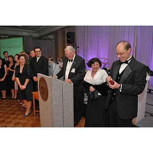 President Aoun opening a small gift at the Huntington Society Dinner