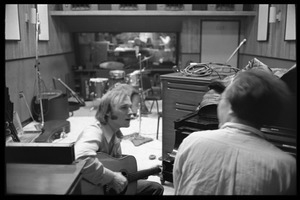 Stephen Stills with his guitar talking with Michael Sahl on piano at Wally Heider Studio 3 during production of the first Crosby, Stills, and Nash album