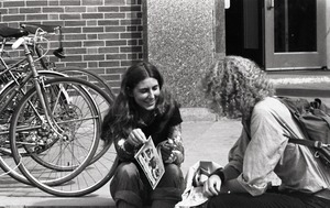 Free Spirit Press crew distributing the magazine to a young woman outside the UMass Amherst Student Union