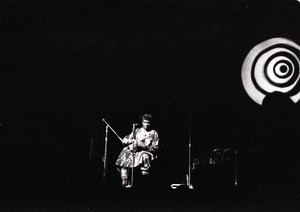 Taj Mahal in concert at Northfield, Mass.: Taj Mahal seated, playing guitar