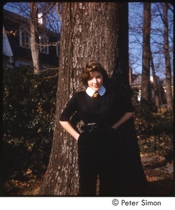 Lucy Simon posing in front of a tree