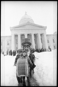 Bread and Puppet Theater descending the steps at the Vermont State House, follow a man with a bass drum, during a demonstration against the invasion of Laos