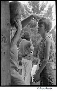 Ram Dass laying on hands on a woman, Rowe Center spiritual retreat