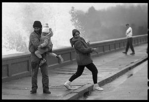 Judy Salonia, her husband Vincent, and daughter Ashley (4) dodge a wave crashing over the Narragansett seawall