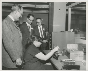 Attendees observe an ICD client at work at the 1959 Rehabilitation Counselors Conference