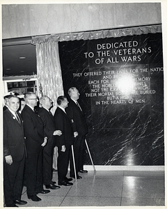 Mayor John F. Collins with group of unidentified men next to unidentified veterans memorial