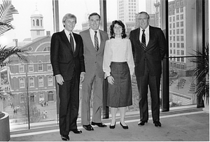 Mayor Raymond L. Flynn in his office with two unidentified men and an unidentified woman