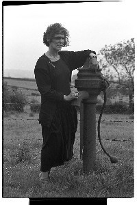 Seamus Heaney's sister Anne at the old water pump at their Bellaghy home
