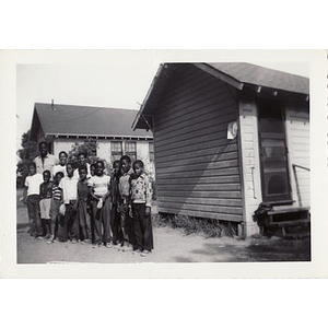 A group of young campers pose in front of the cabins at Breezy Meadows Camp
