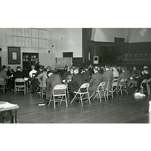 Boys' Club staff members seated in an auditorium for an administrative meeting