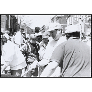 Several staff members preparing food at the Boys and Girls Clubs of Boston 100th Anniversary Celebration Street Fair