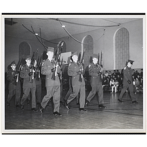 The Boston University drill team performs in a gymnasium