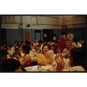 A group of children and adults attend a dinner