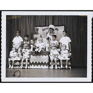 Group portrait of the Little Sister Contest winners with their brothers and two judges