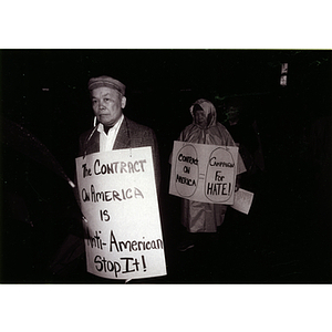 Two Asian people demonstrate for immigrant rights