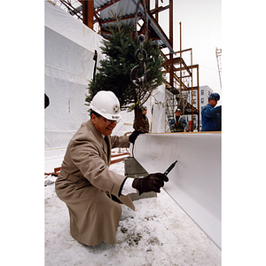 Roger M. Marino signing the foundation at the construction site of the Marino Recreation Center